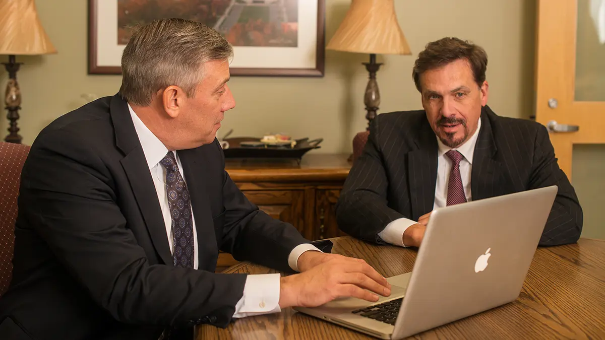 Ed Dougherty and Philip Holloway consulting with a personal injury client